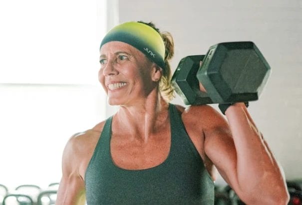 The Menopause Metabolism SHift: Why Weight Gain Happens and how to take control 1 Older woman on Legends class working out with dumbbell